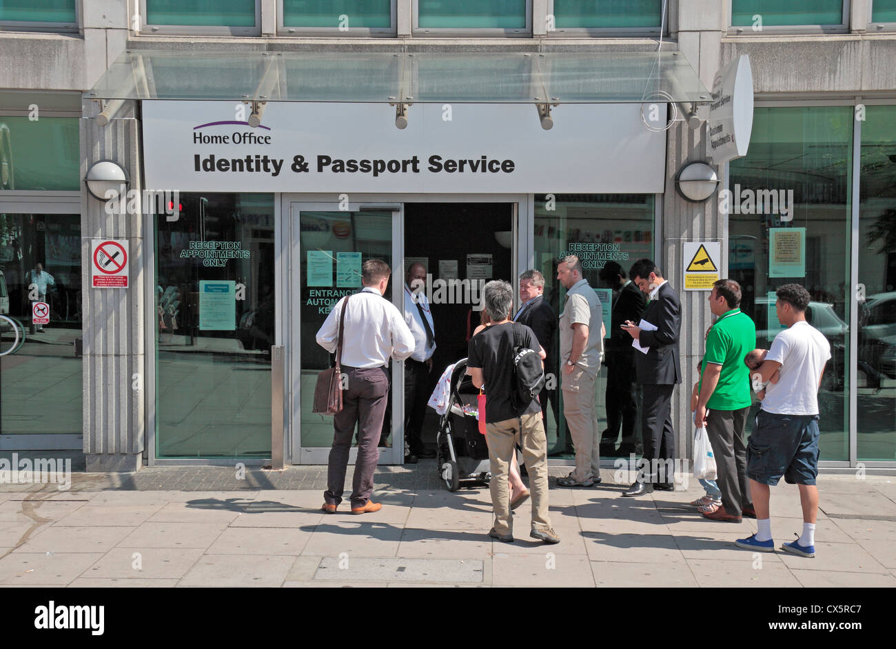 People queuing outside the Identity and Passport Service office, Globe  House, 89 Eccleston Square, London, UK Stock Photo - Alamy