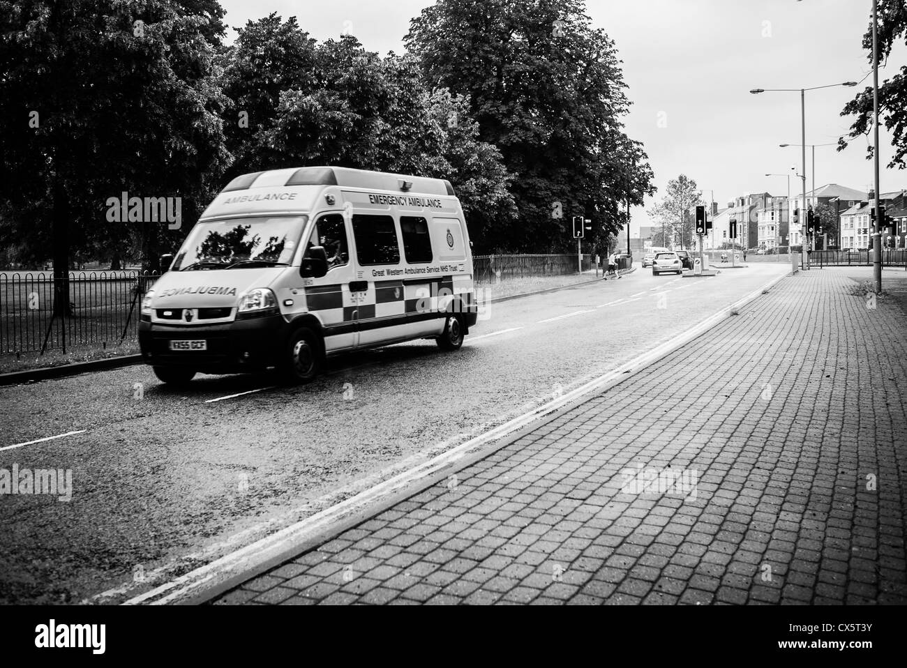 An ambulance races on the wrong side of the road to an emergency Stock Photo