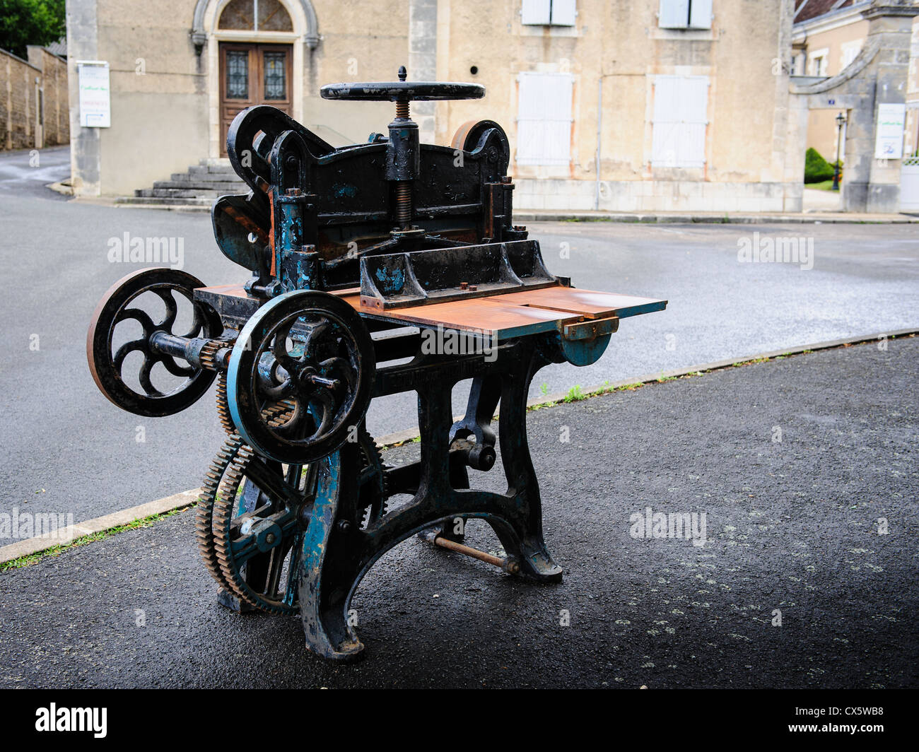 Old printing press used as street furniture in the book town of