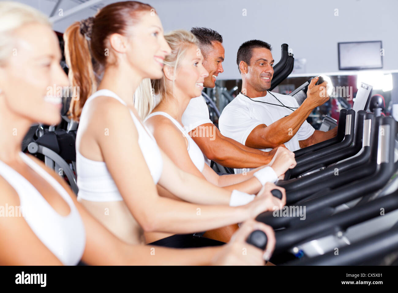 sport coach training cyclists in gym Stock Photo