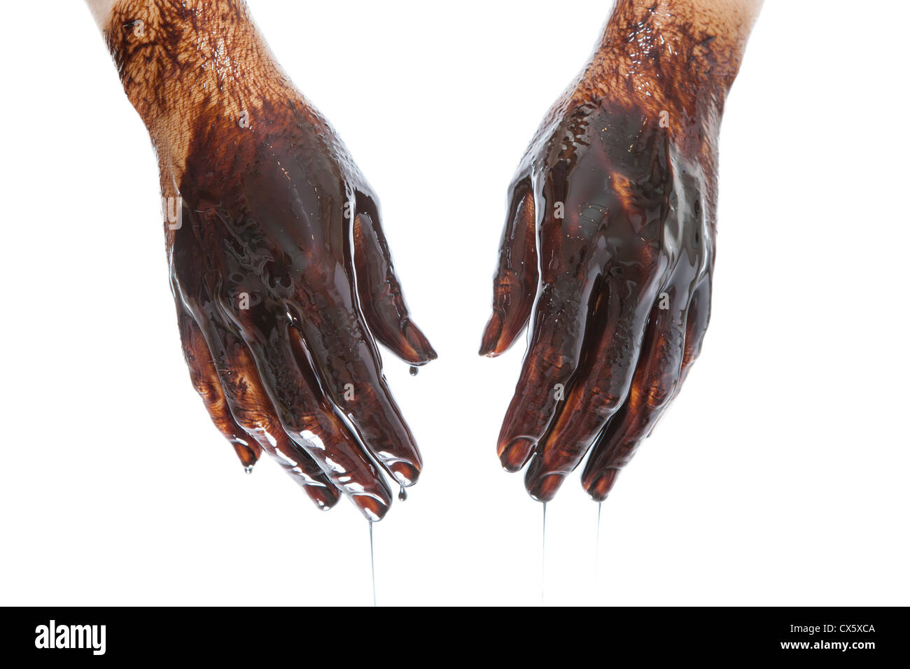 Caucasian hands cupped with black petroleum isolated on white background Stock Photo