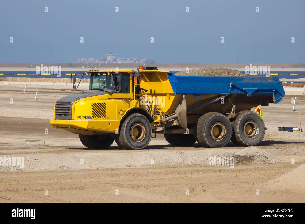 Dump truck at a construction site in the harbor of Rotterdam. Stock Photo