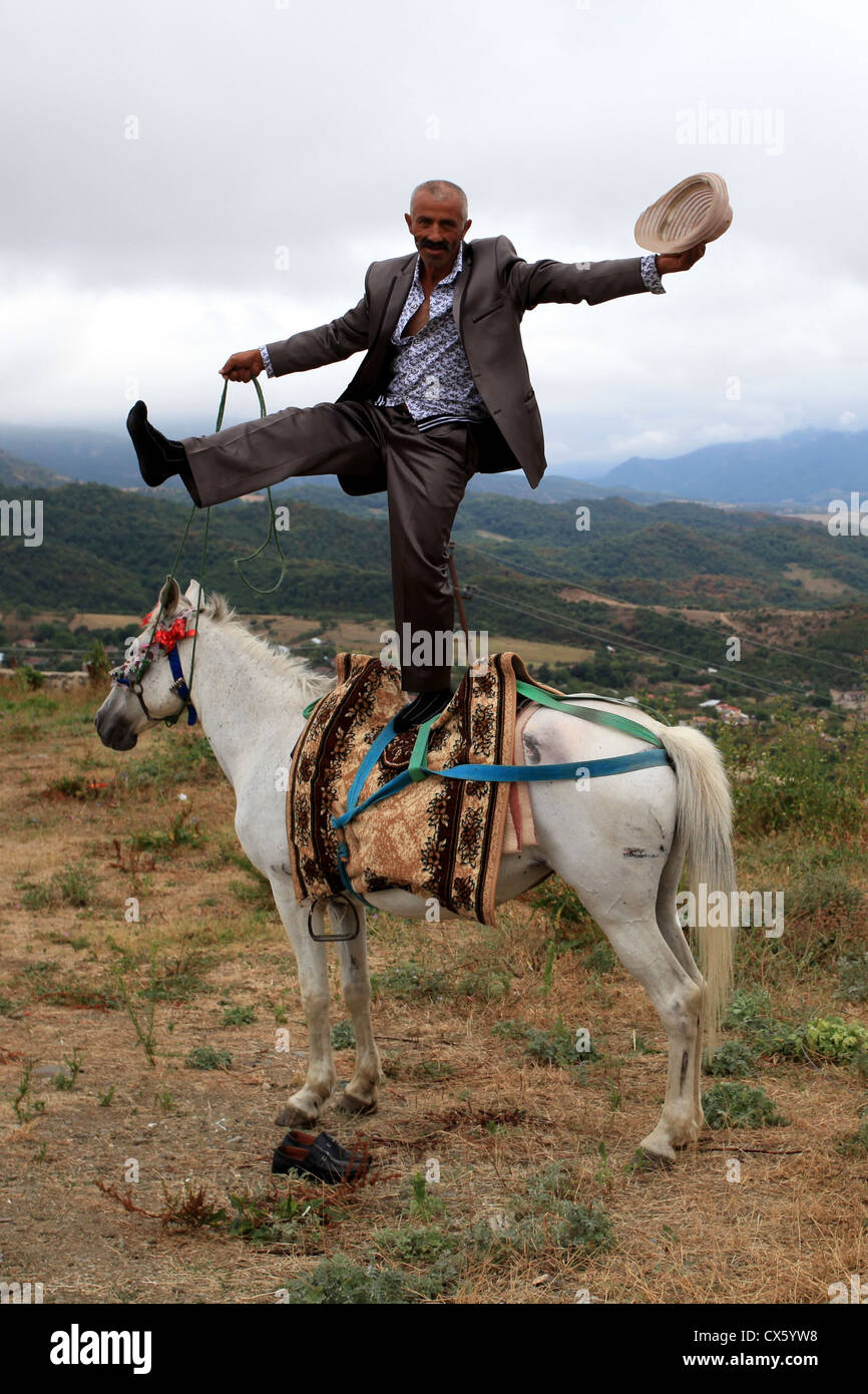 Welcome to Nagorno-Karabakh. The man is performing a cheap stunt for Gandzasar monastery’s visitors. Stock Photo