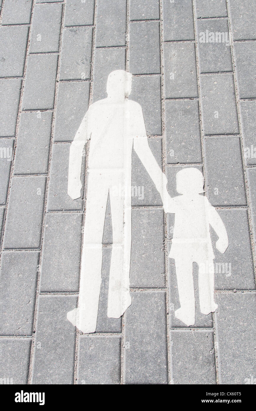 white silhouette walking adult and child on strreet tile Stock Photo