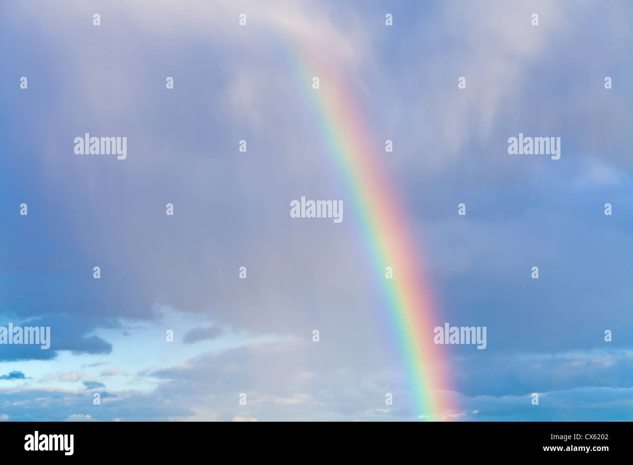 rainbow in autumn blue cloudy sky Stock Photo - Alamy