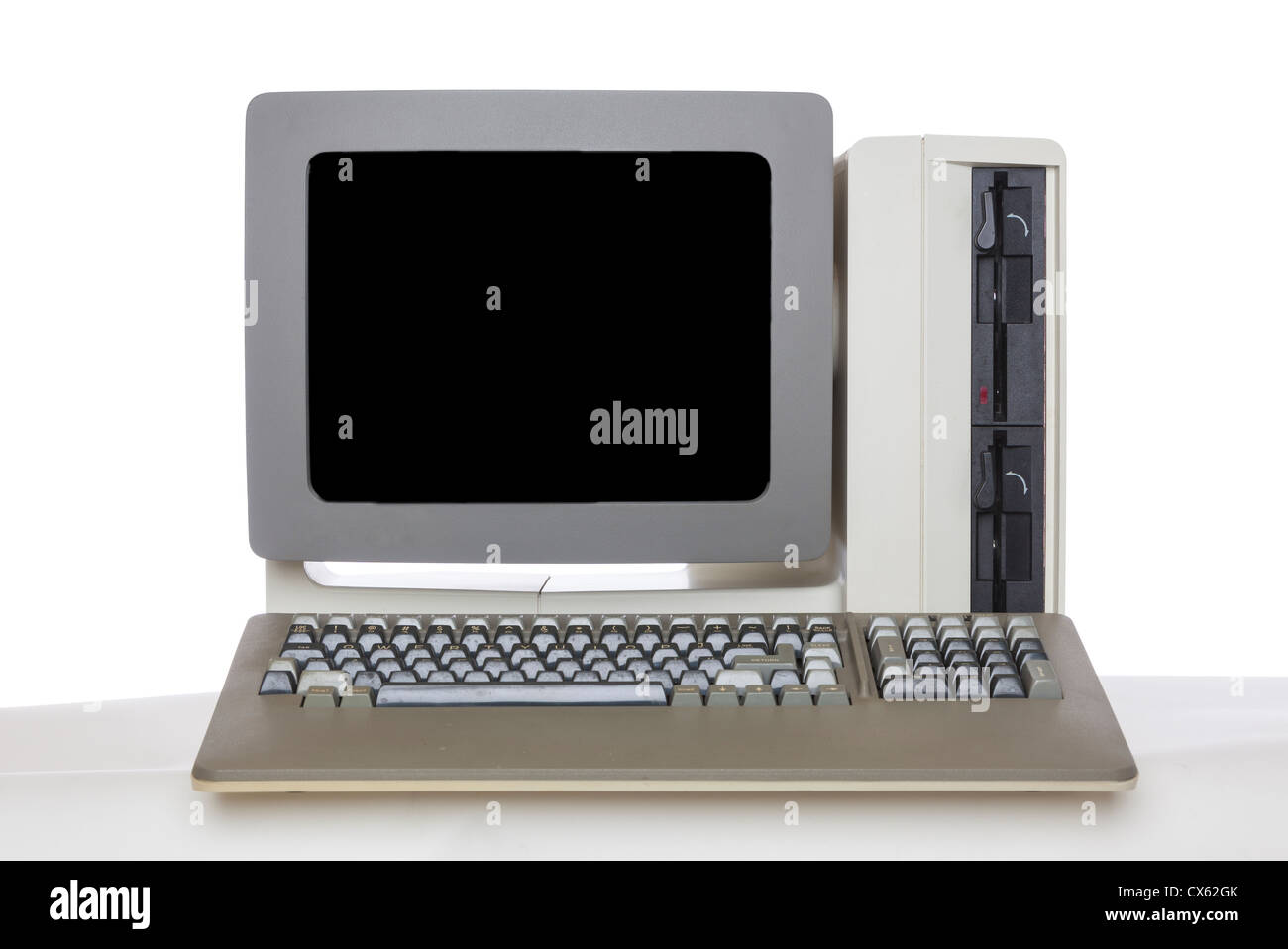 1980's PC desktop computer and monitor with 5 1/4 floppy disc drives and floppy discs. Stock Photo