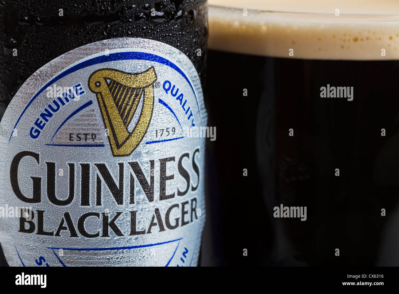 Dublin, Ireland - September 12, 2012. This is a studio product shot of a can of Guinness black lager next to a glass of freshly Stock Photo