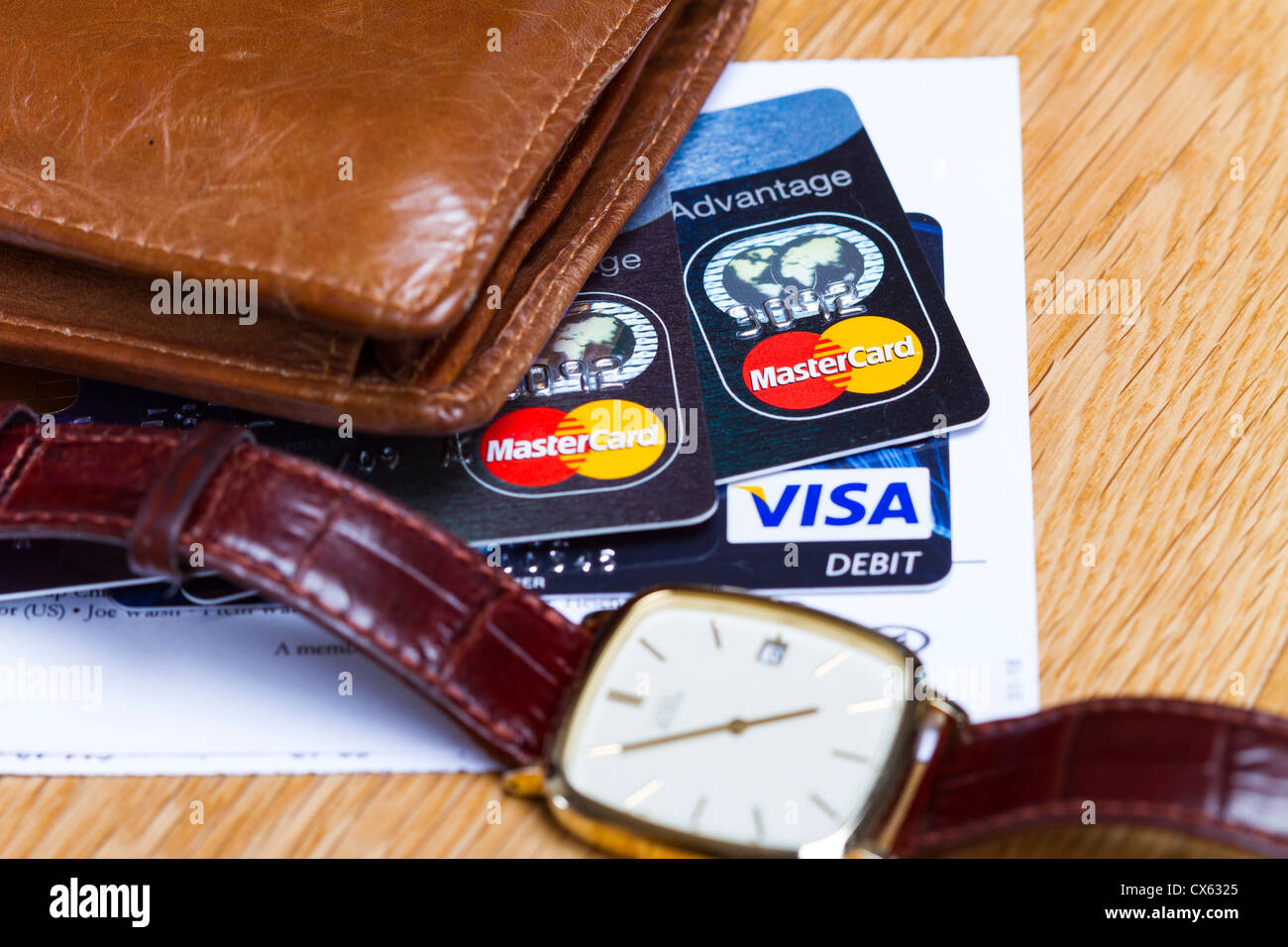 Mastercard & Visa Debit card along with a wallet and a watch Stock Photo