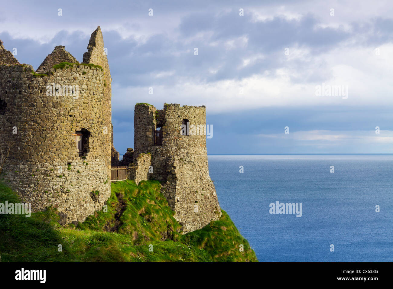 Dunluce Castle is a now-ruined medieval castle in Northern Ireland. It is located on the edge of a basalt outcropping in County Stock Photo
