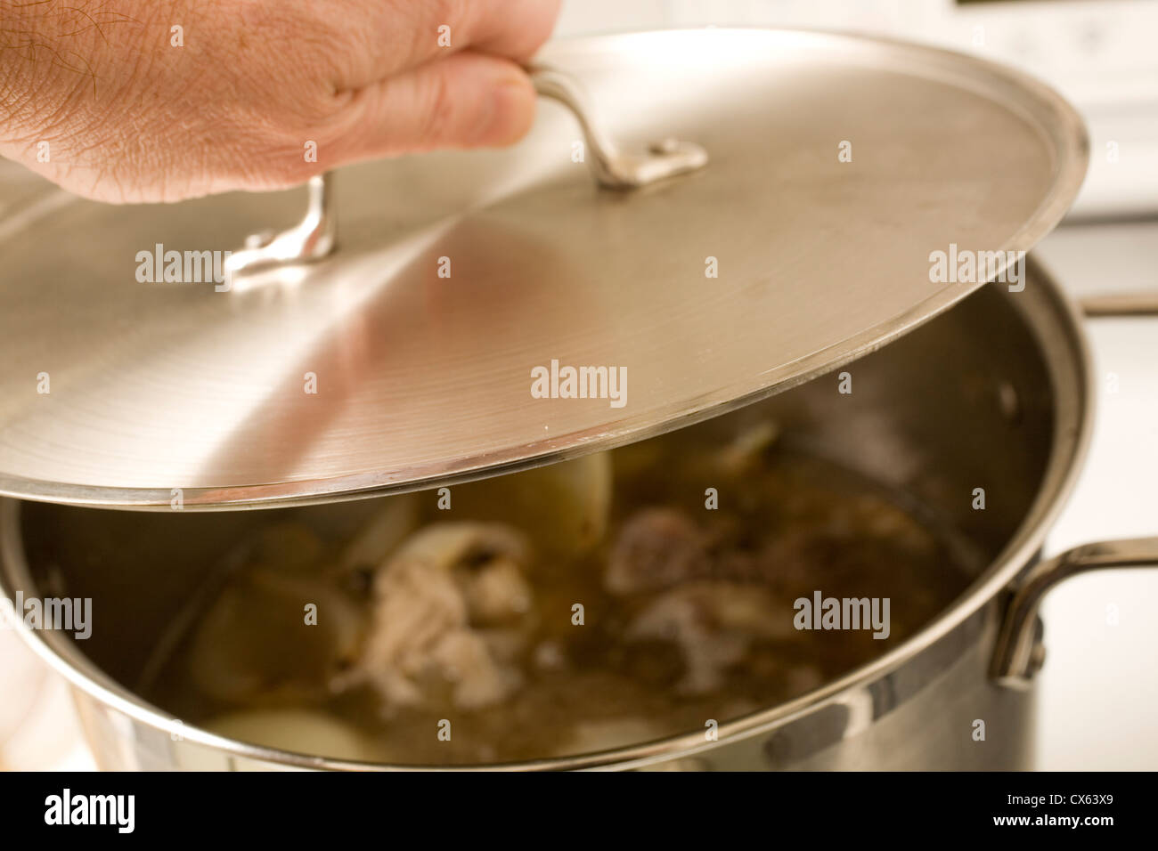 Beef broth simmering in a pot Stock Photo Alamy