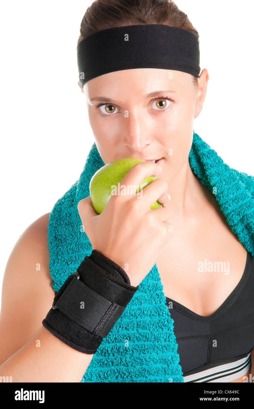Woman about to eat a green apple after her workout at the gym Stock Photo Alamy