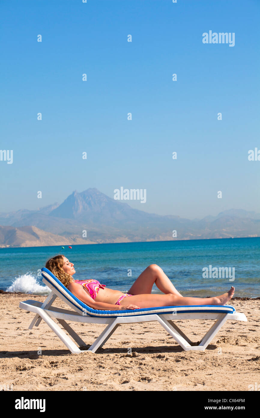 Woman sunbathing San Juan beach Alicante, Spain Stock Photo