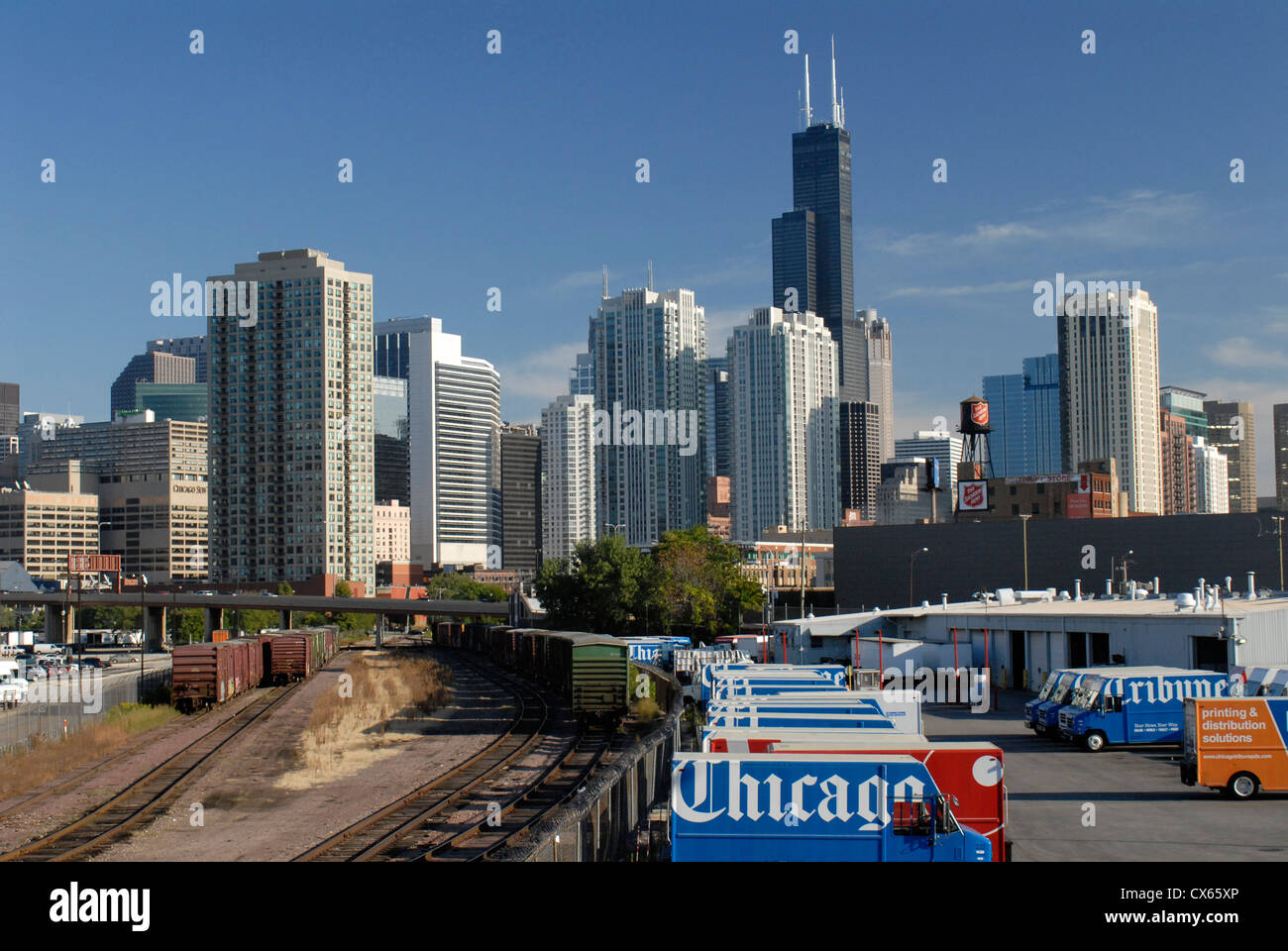 Chicago Tribune newspaper trucks and Chicago skyline, Illinois. The Willis Tower is the tall black building. Stock Photo