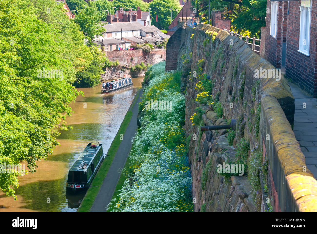 Narrowboats in Canal Cutting on the Shropshire Union Canal & The City Walls, Chester, Cheshire, England, UK Stock Photo
