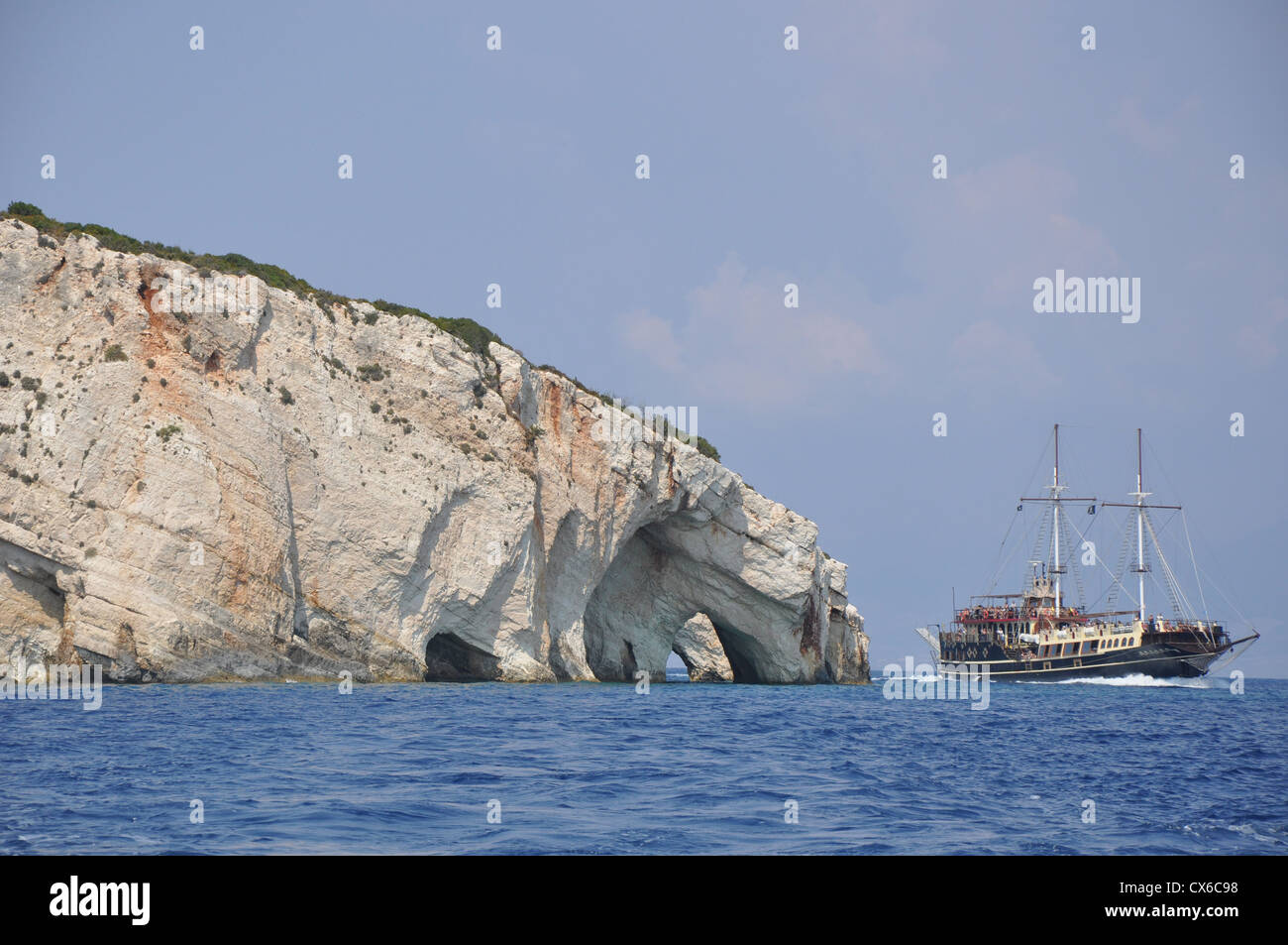 Blue caves on Zakynthos island, Greece, and a ship passing by Stock Photo