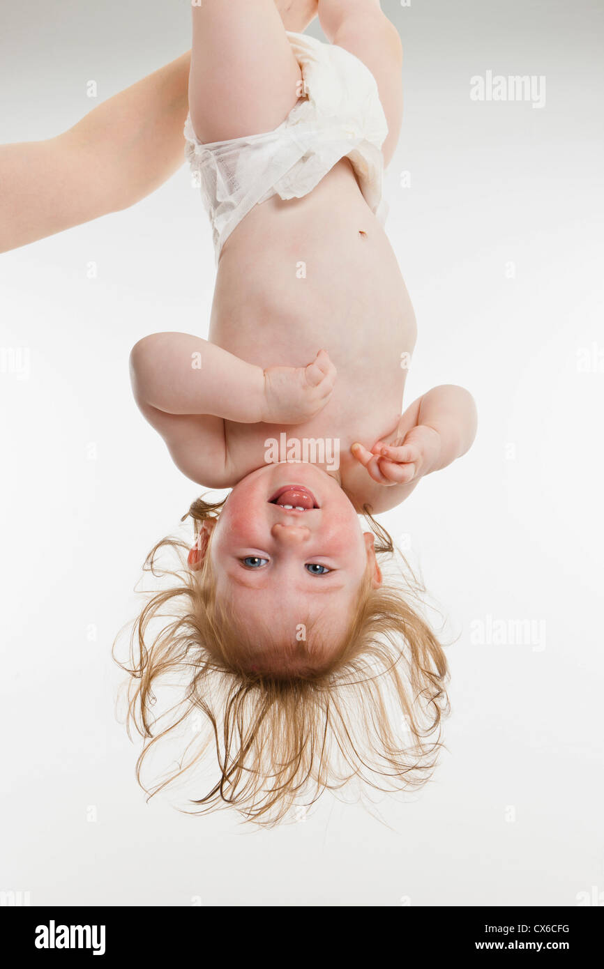A Baby Girl Held Upside Down Stock Photo Alamy