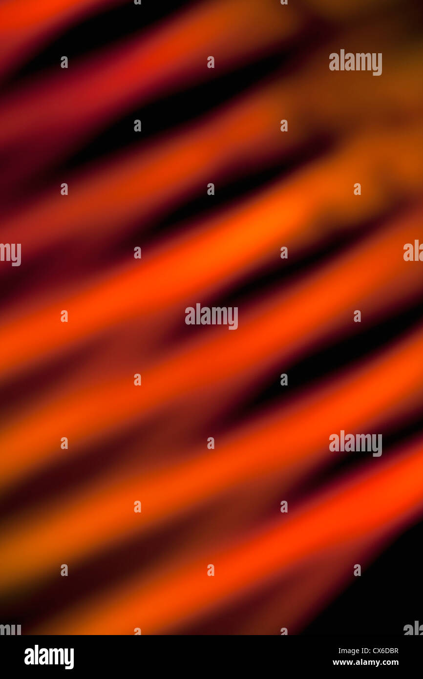 Orange and red slanted lines created by a light effect, close-up, defocused Stock Photo