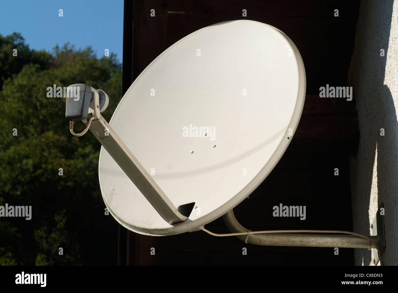 satellite television dish on the house wall Stock Photo