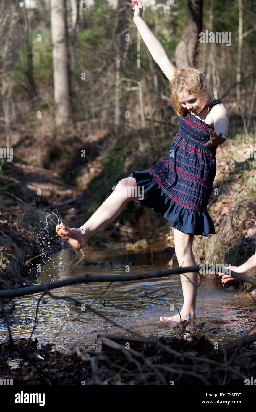 Girl kicking her feet through the water in Mooresville, North Carolina, USA Stock Photo