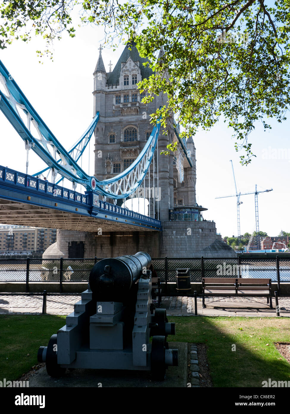 View of Tower Bridge and a Cannon from the North Bank of the River Thames, London, UK Stock Photo