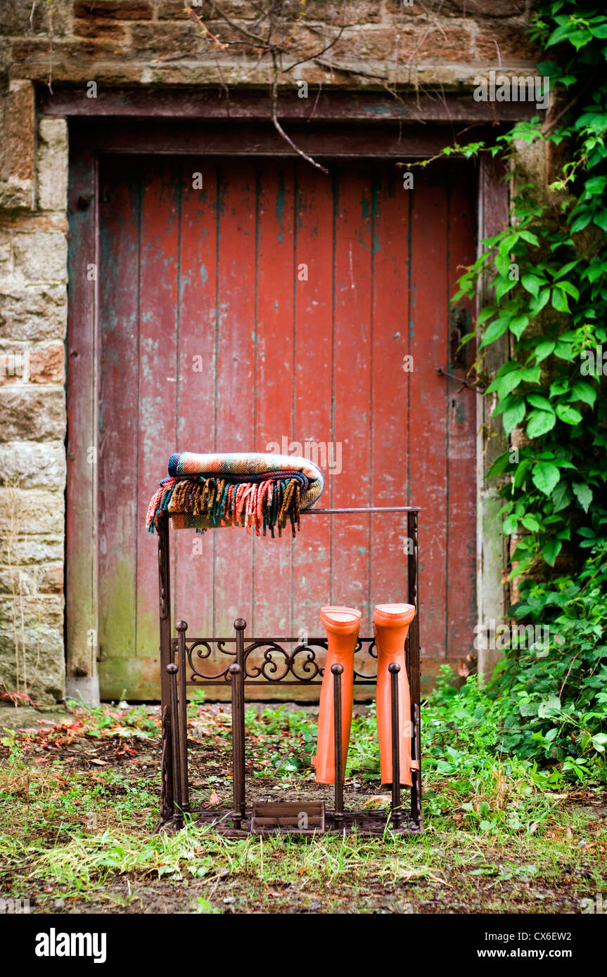 Blanket and Wellington boots in garden Stock Photo - Alamy