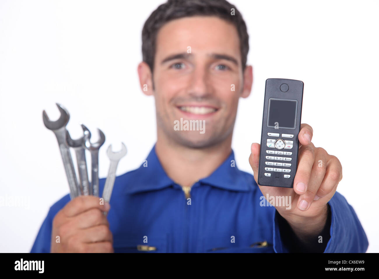 Mechanic showing mobile phone Stock Photo Alamy