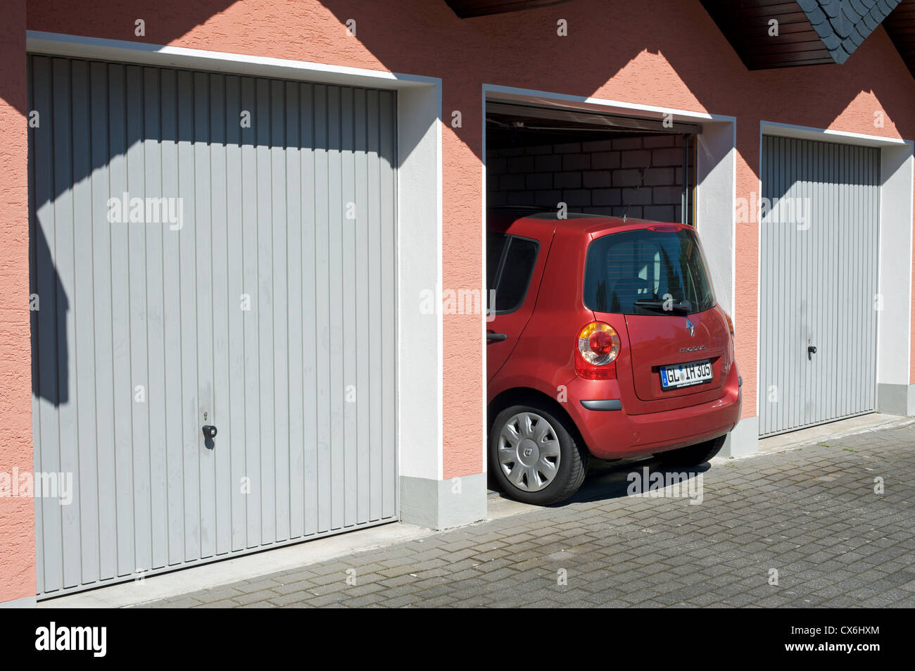Car being driven into garage Stock Photo