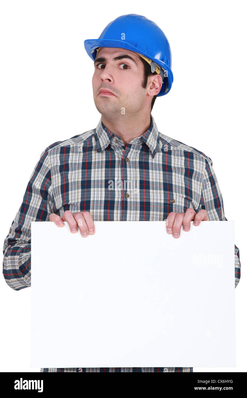 Unsure construction worker holding up a blank sign Stock Photo - Alamy