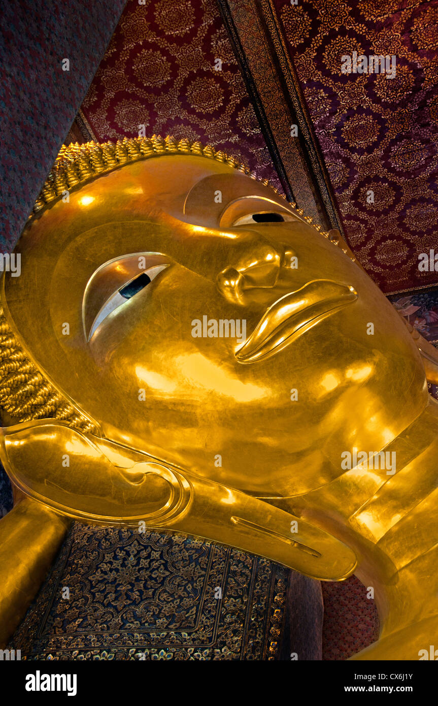 Big Reclining golden Buddha statue (Phra Buddhasaiyas) at Wat Pho Bangkok 46 m long Thailand Stock Photo