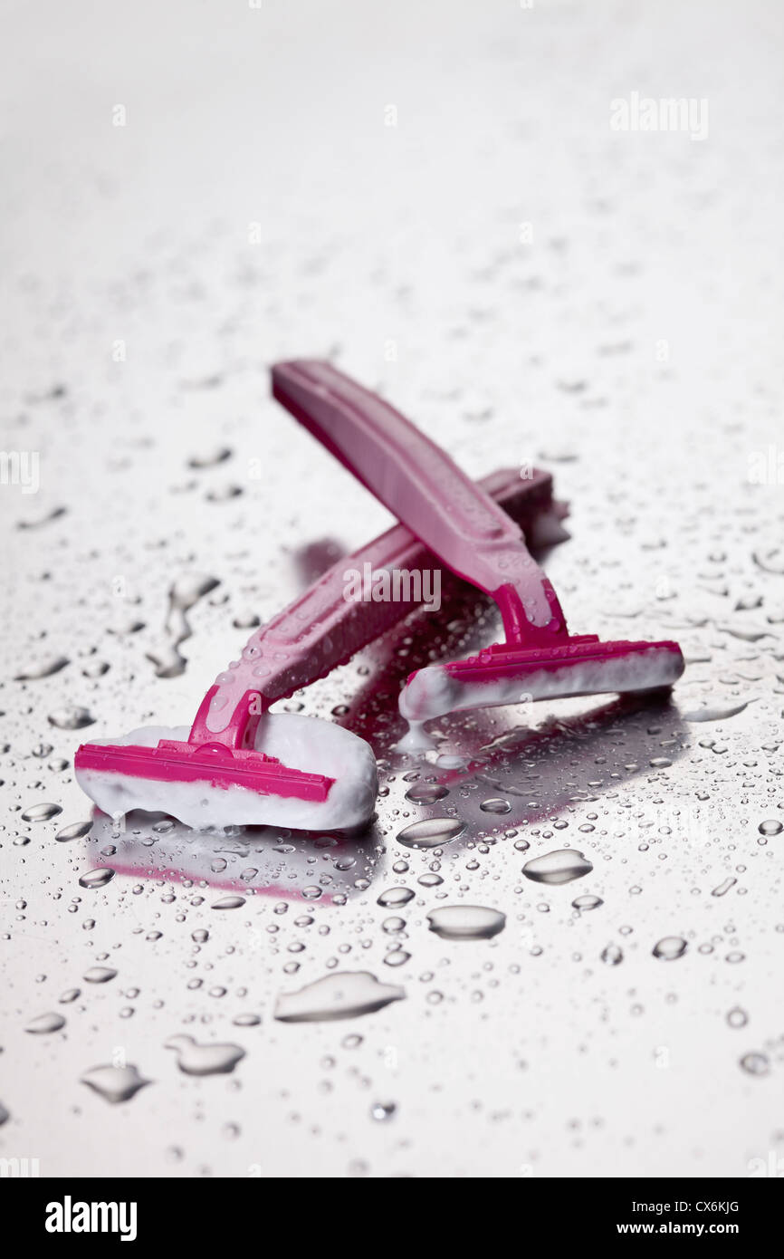 Two disposable razors with shaving cream on them Stock Photo Alamy