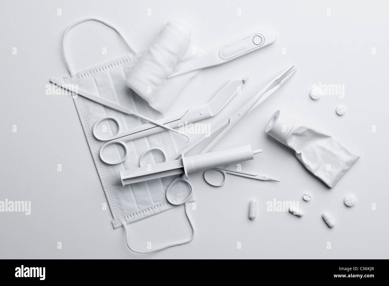 Medicine and medical equipment painted white and scattered on a white surface Stock Photo