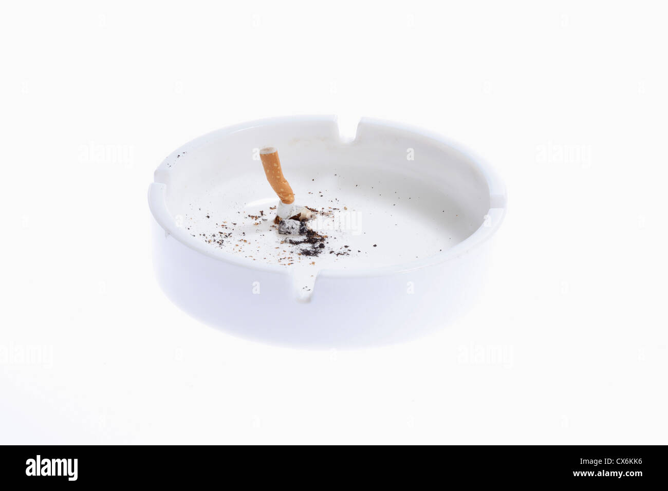 A cigarette butt put out in a white ashtray Stock Photo Alamy