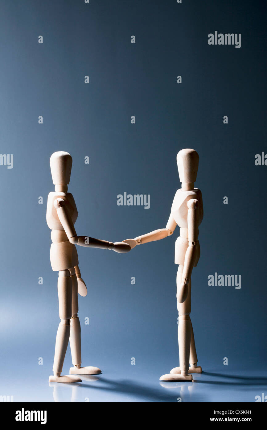 Two artist's figures shaking hands Stock Photo