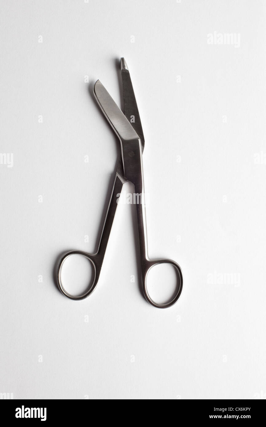 A pair of surgical scissors on a white surface Stock Photo