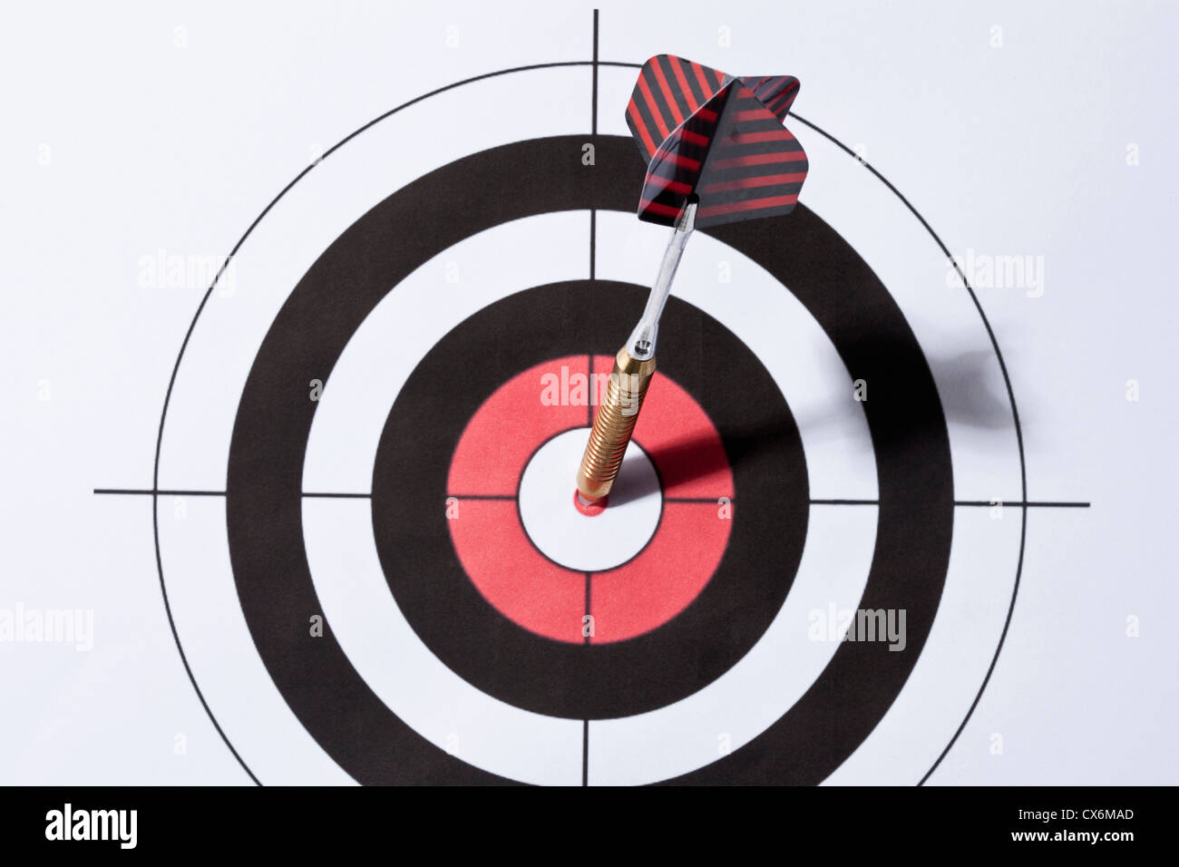 A dart in the bull's eye of a target Stock Photo