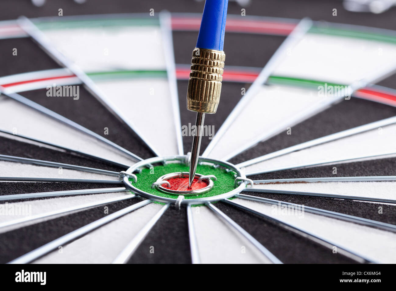Extreme close up of a dart in a bull's eye Stock Photo