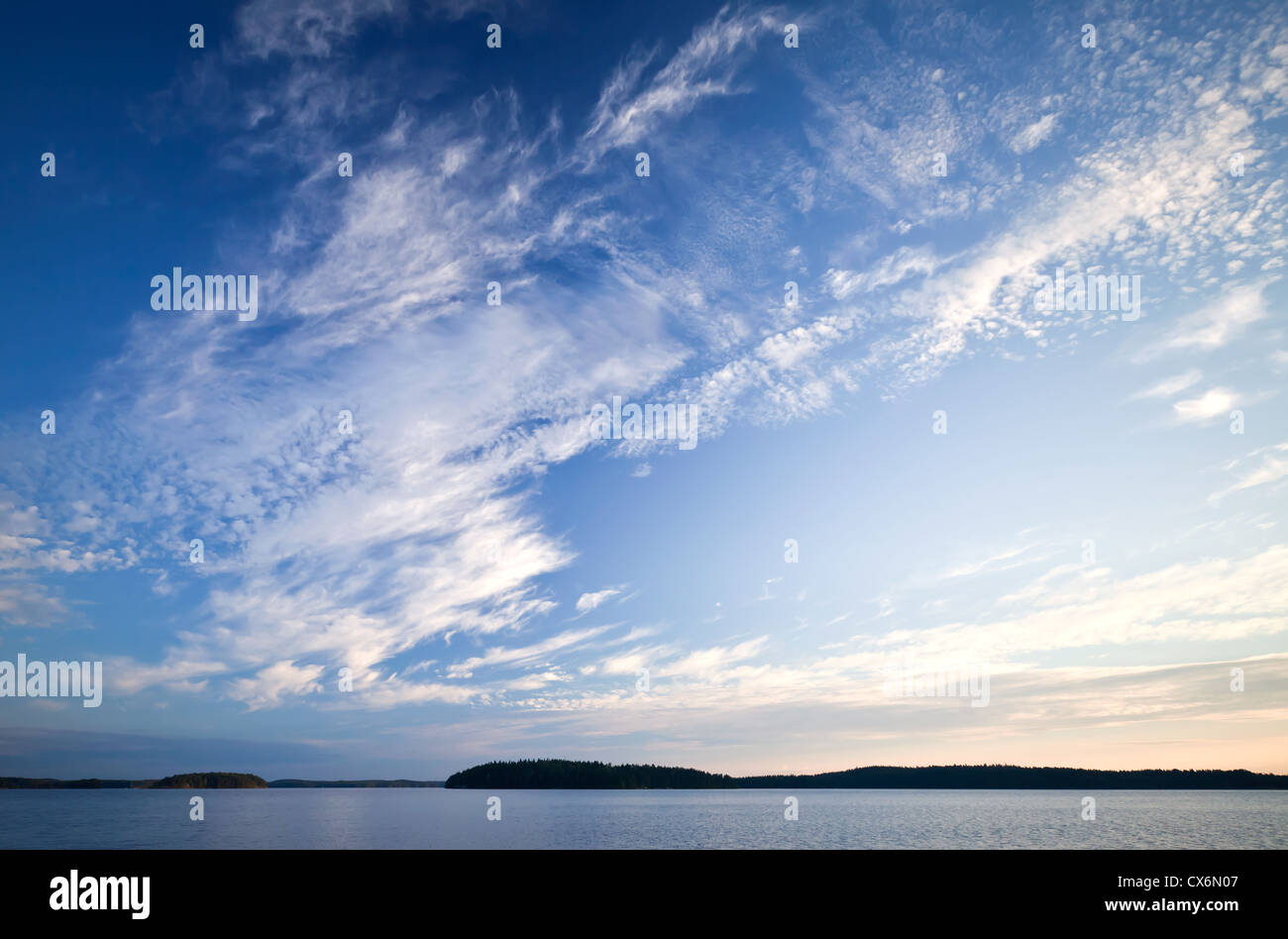 Coastline of the lake with beautiful cloudy sky above this Stock Photo
