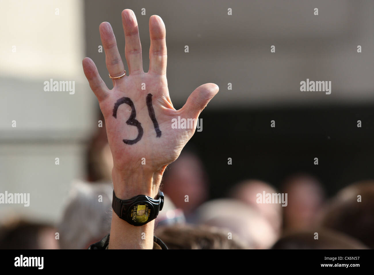 Hand of protester showing number 31, meaning article 31 of Russian Constitution which guarantees right to peacefully demonstrate Stock Photo