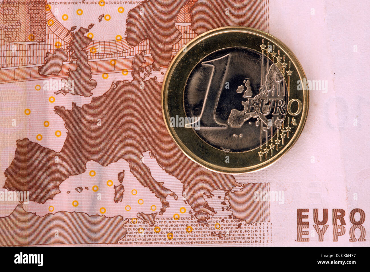 Detail of a ten Euro banknote with a one Euro coin on top of it Stock Photo