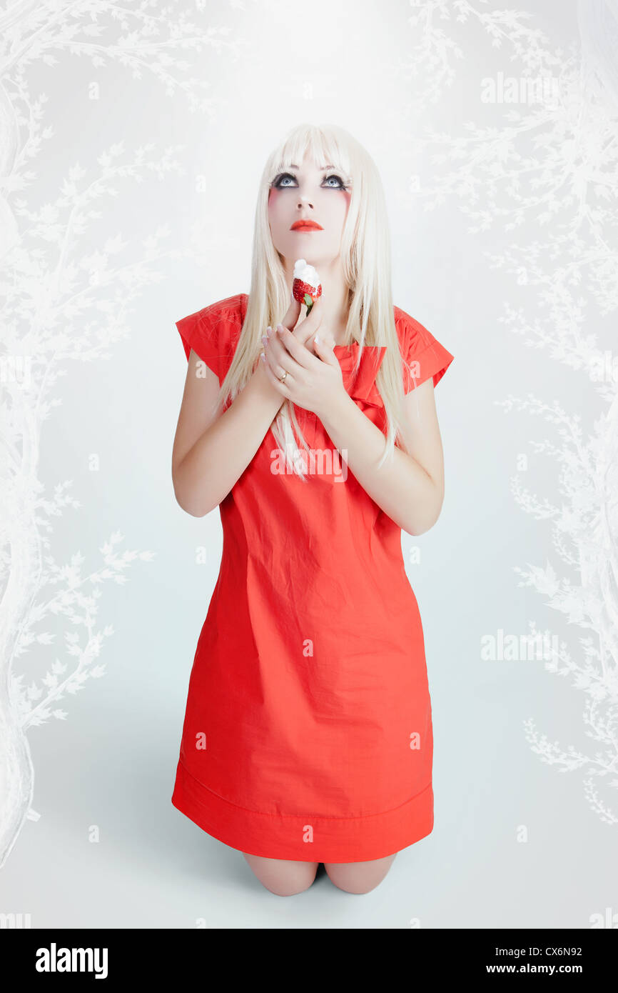 Woman in red dress kneeling hi-res stock photography and images - Alamy