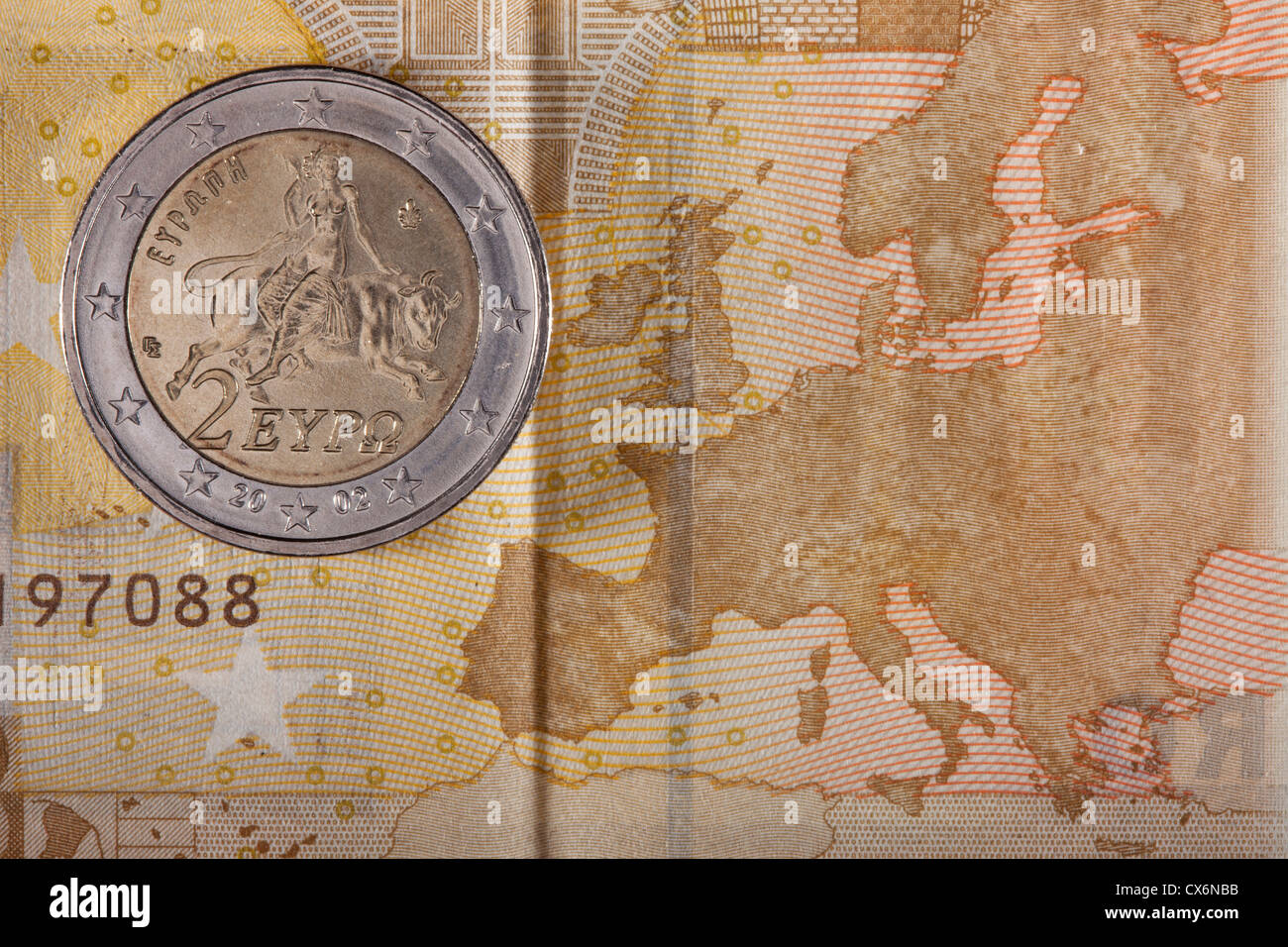 Detail of a fifty Euro banknote with a two Euro coin on top of it Stock Photo