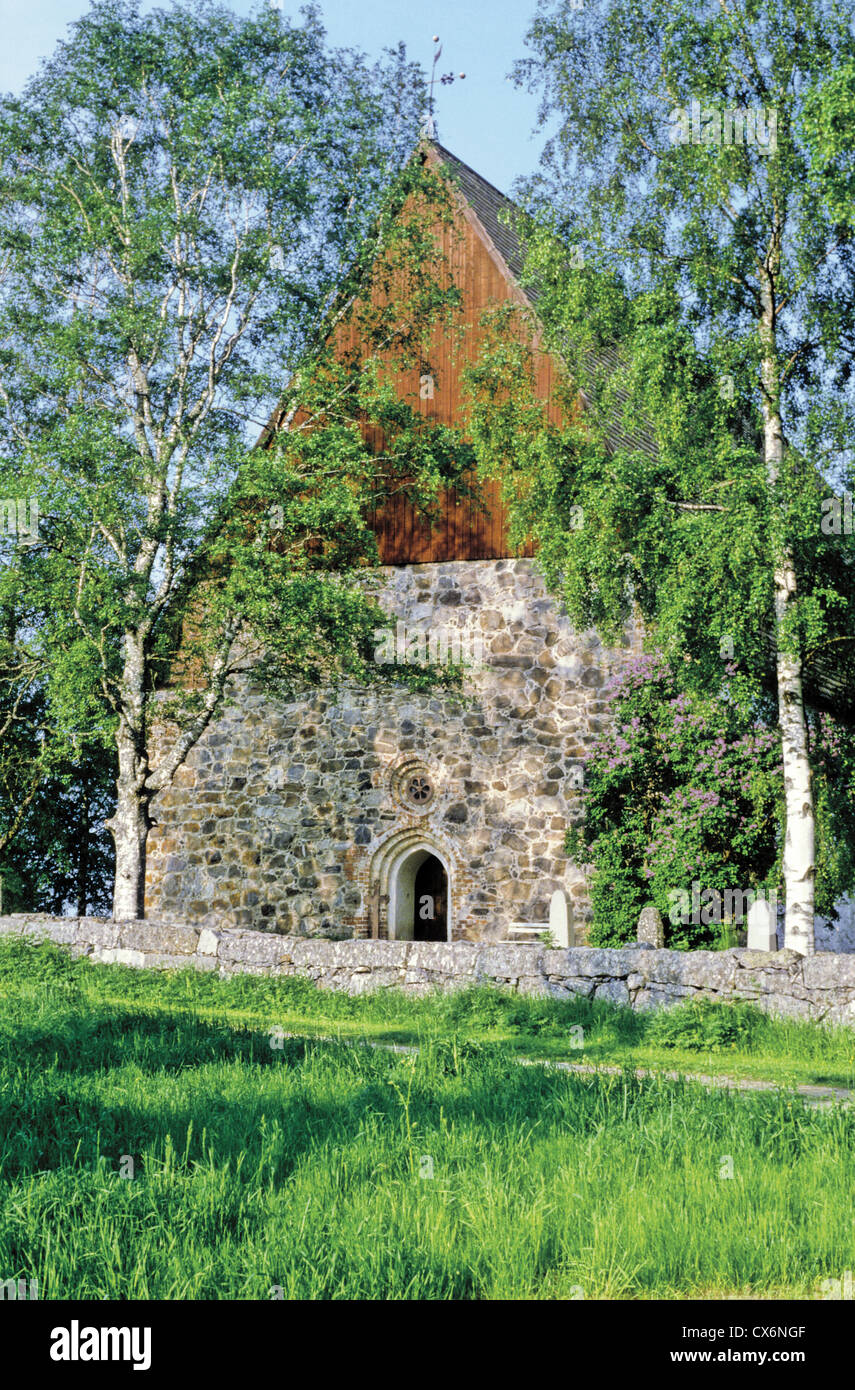 West wall with painted wooden gable of St. Lawrence Church in Isokyro, Finland - The church was built circa 1520. Stock Photo