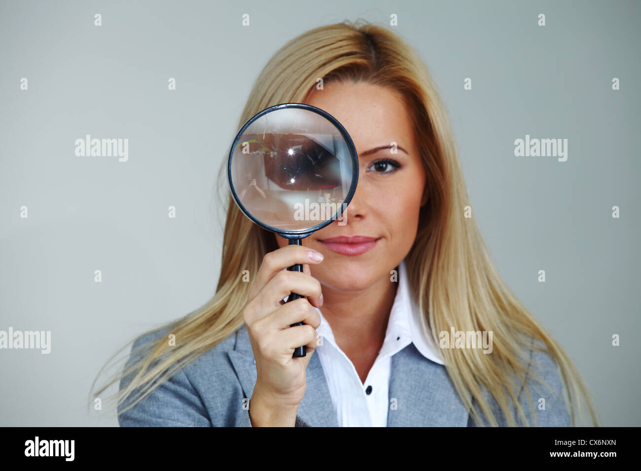 business woman looking through a magnifying glass Stock Photo - Alamy