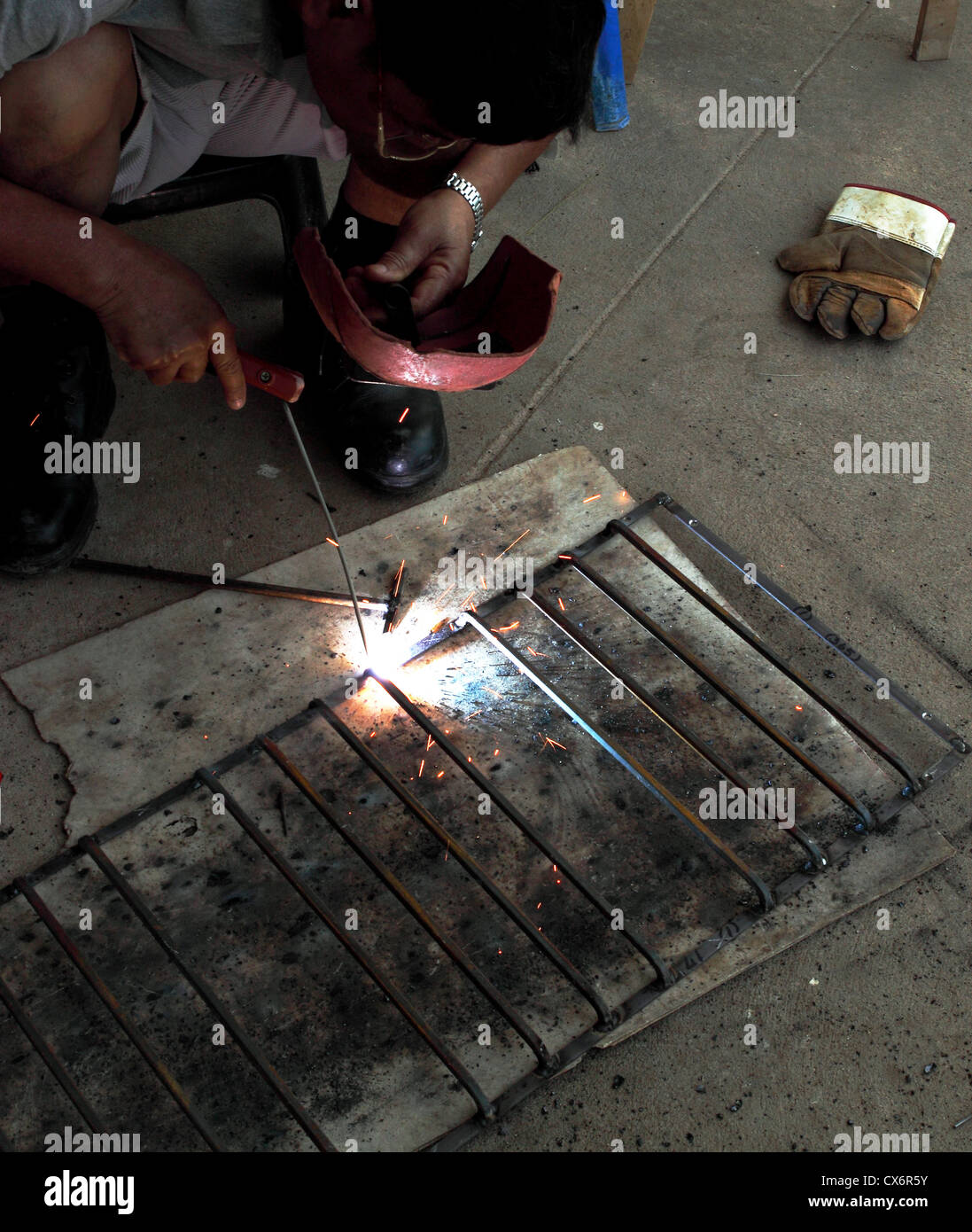 worker welding connecting square bar without gloves Stock Photo