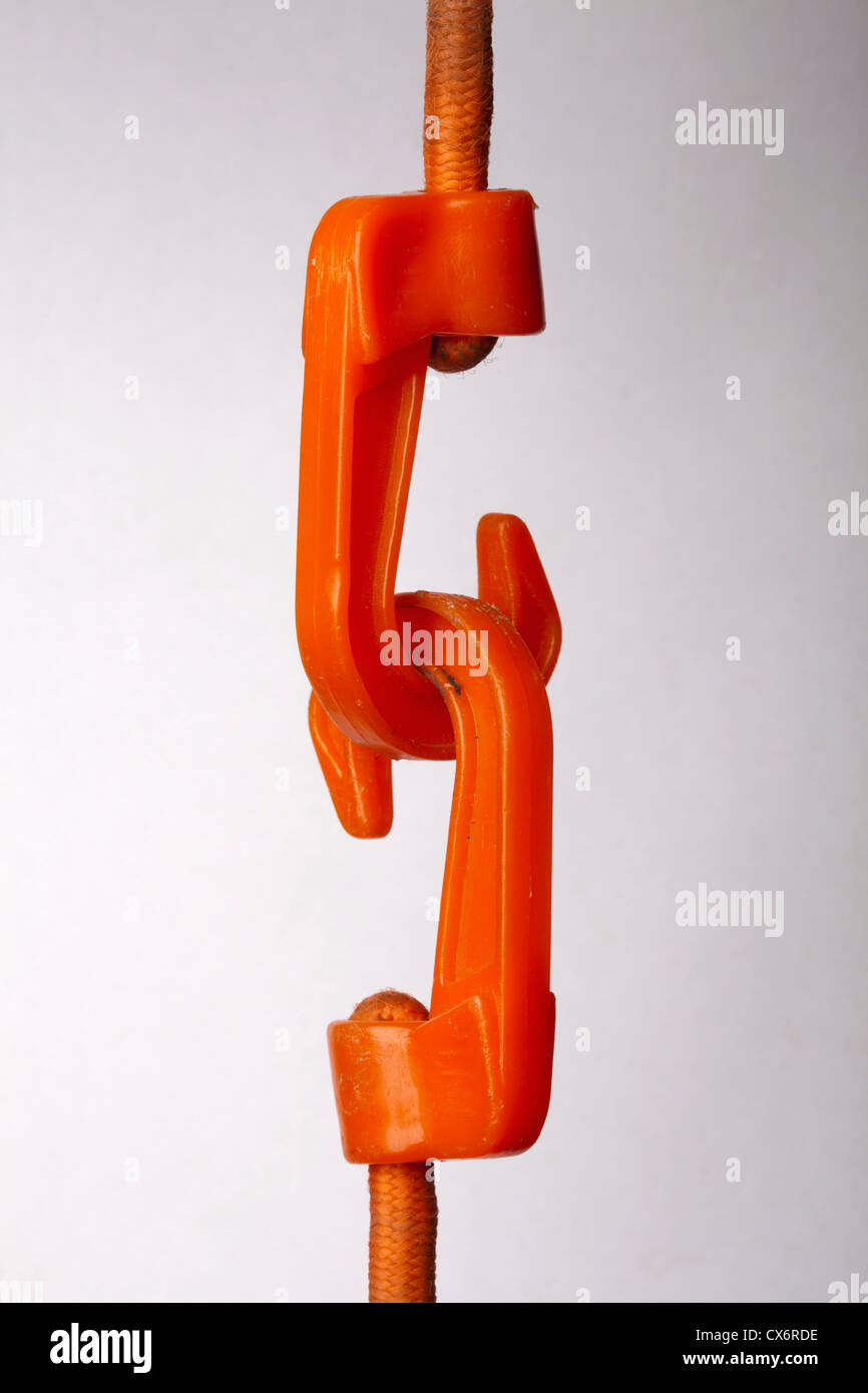 An orange hook attached to a rope pulling another hook attached to a