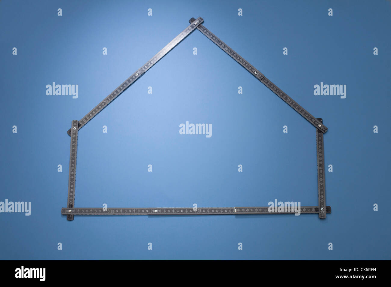 A folding ruler arranged in the shape of a house Stock Photo
