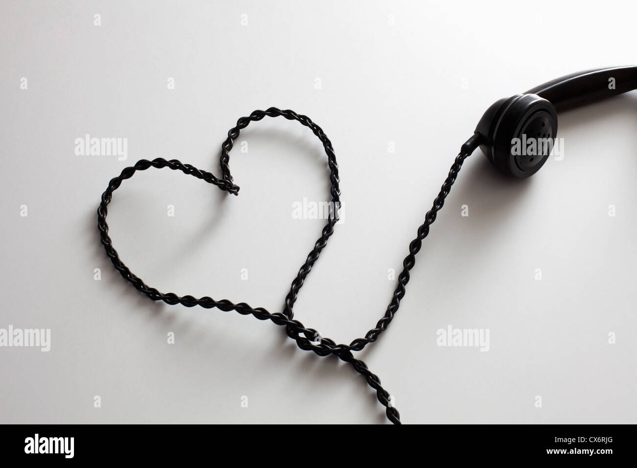 An old-fashioned telephone cord arranged into the shape of a heart Stock Photo