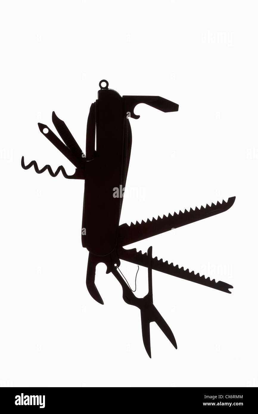 A multi-tool hanging in silhouette Stock Photo
