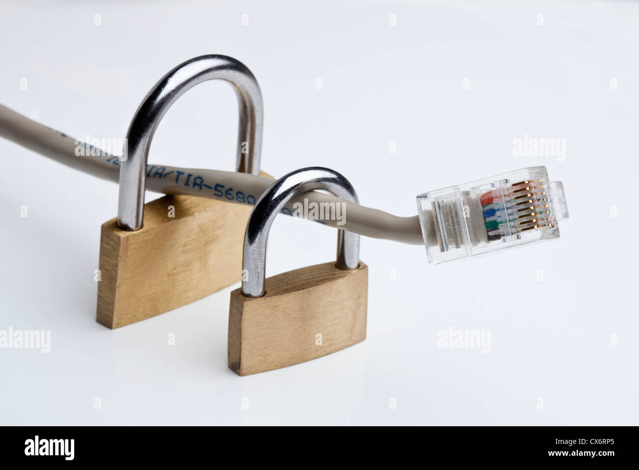 Two padlocks around an Ethernet cable Stock Photo