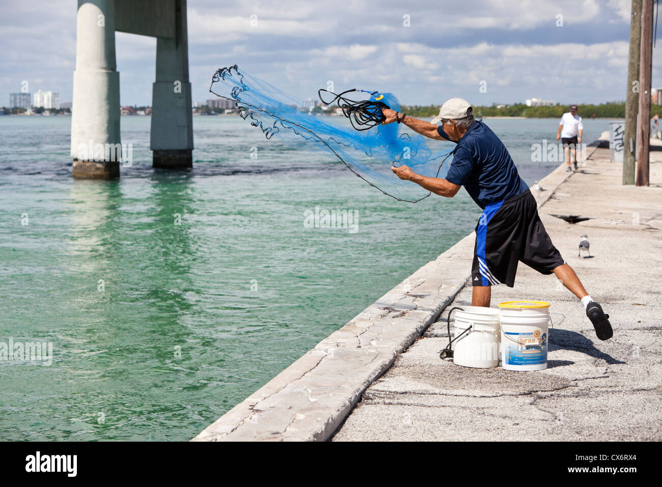Fisherman throwing cast net from land, Haulover Park Bayside, Miami